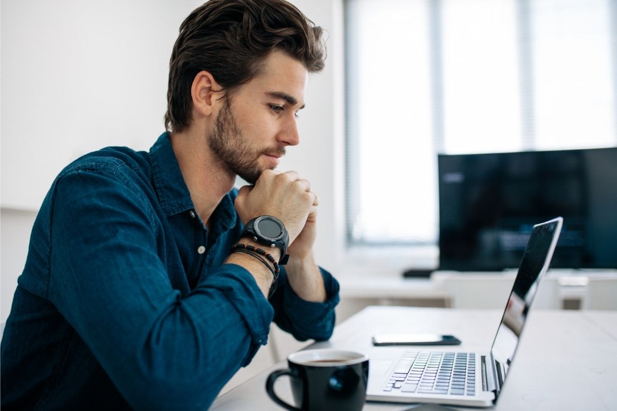 Man looks intently at his computer screen.