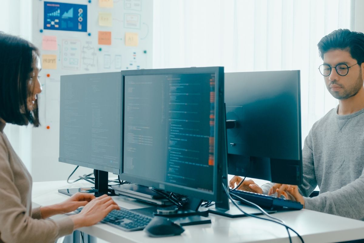 Two individuals working on a software engineering exercise