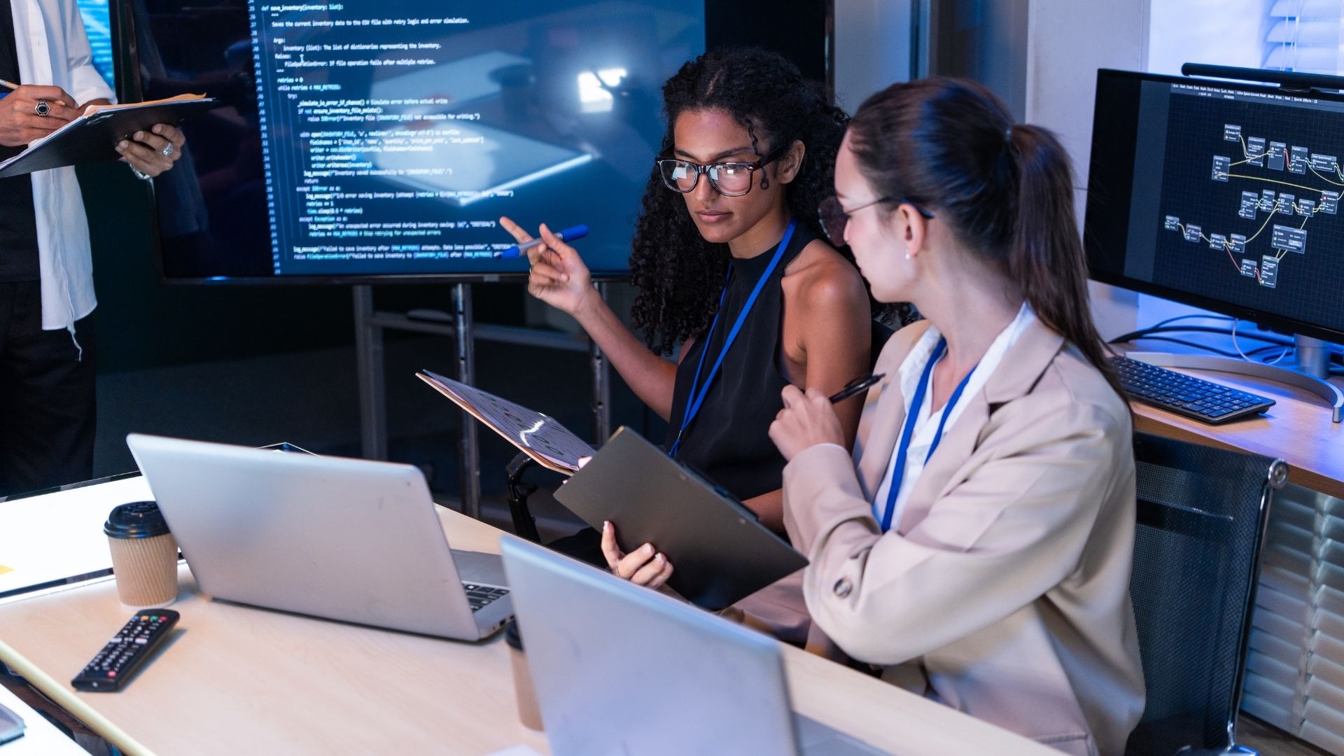 Individuals review information on a computer screen