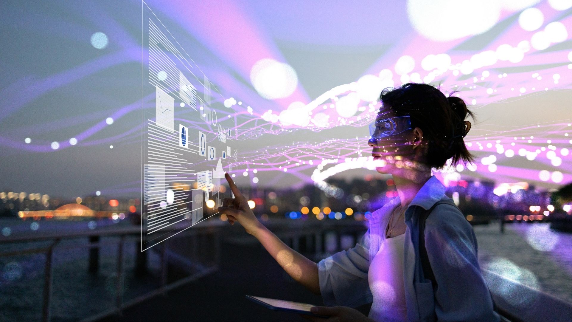 Woman standing in front of a translucent purple screen with data