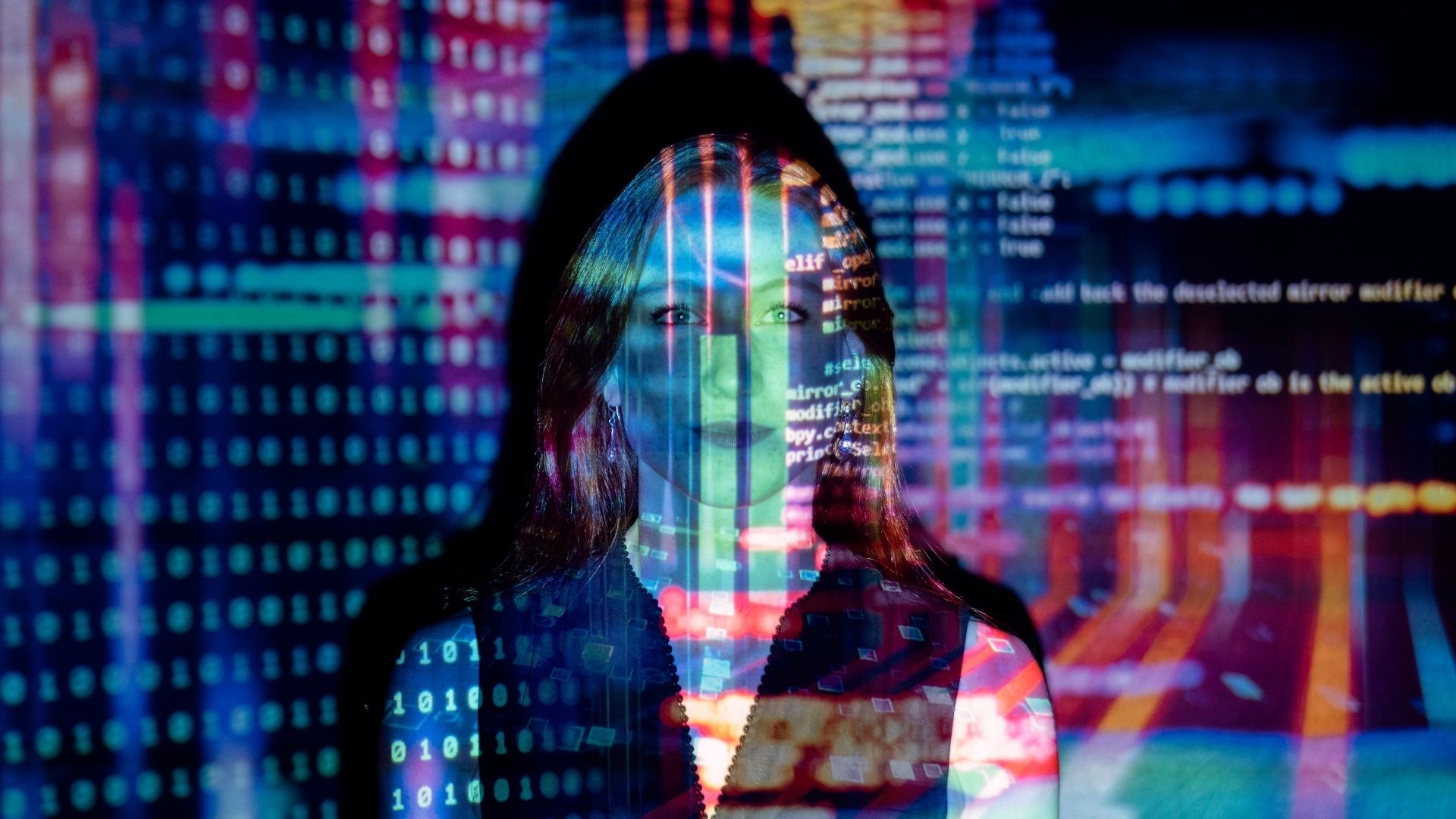 A digital display of code superimposed on a woman's face.