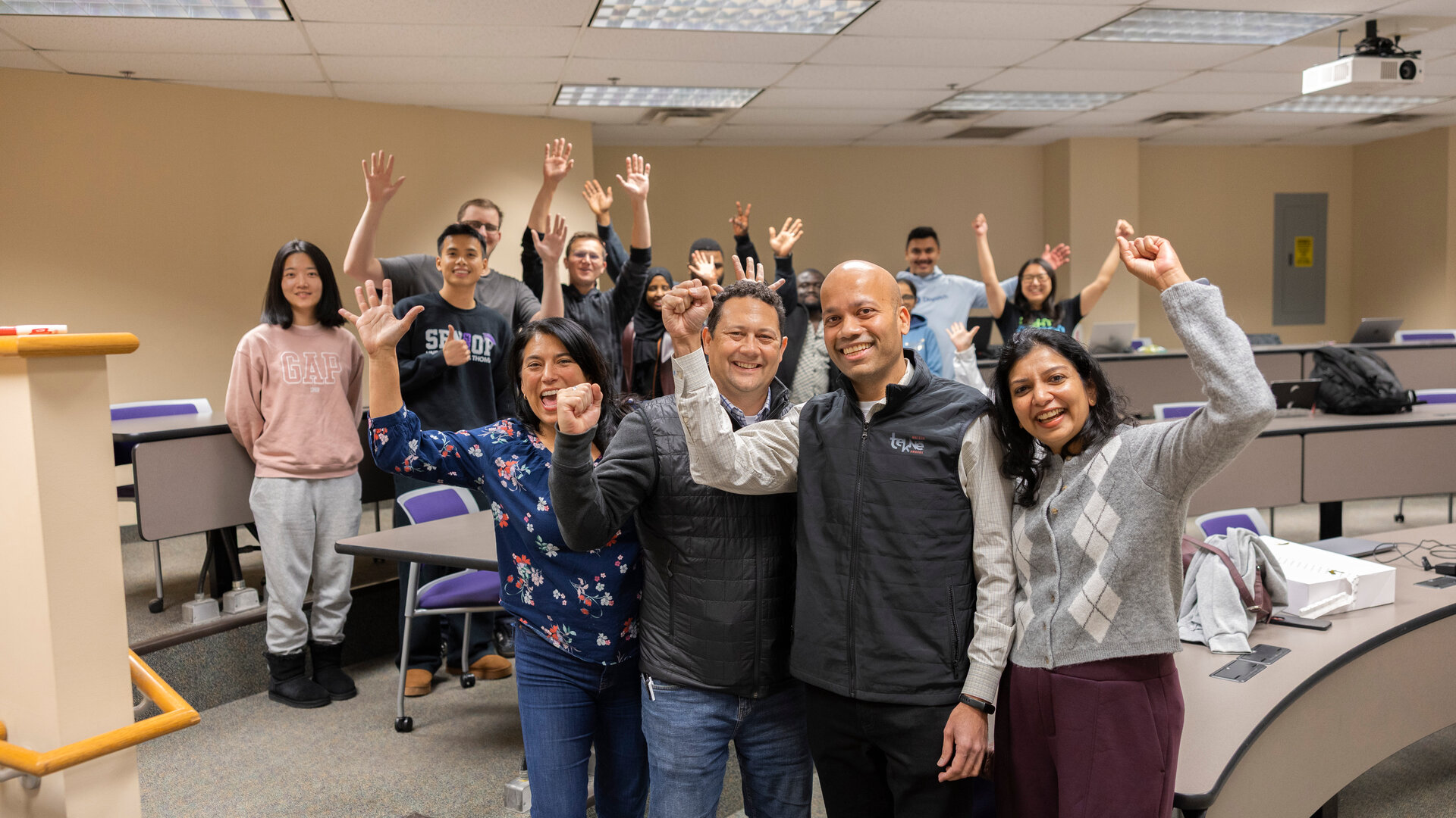 Graduate students celebrate with their professor, Dr. Manjeet Rege.
