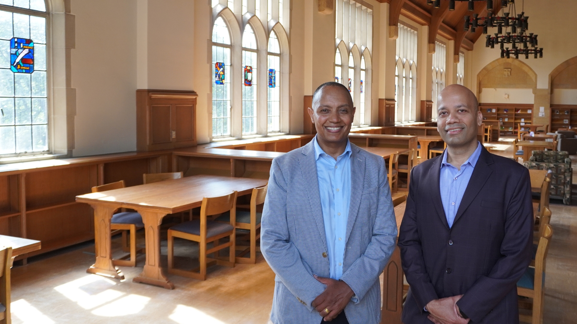 Manjeet Rege and Jote Tadesse stand in the O'Shaughnessy Library