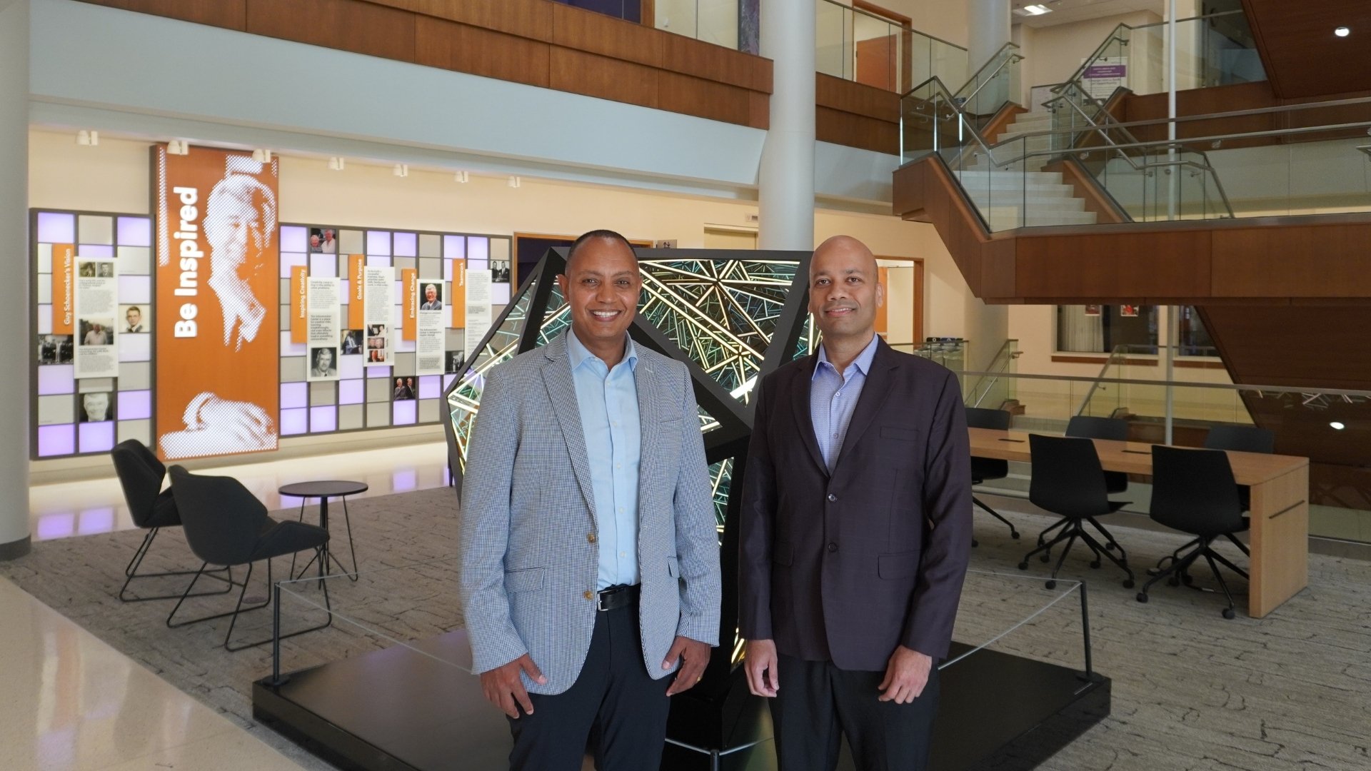 Jote Tadesse and Manjeet Rege pose in the Schoenecker Center