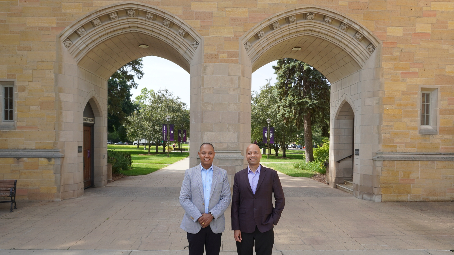 Jote Tadesse and Manjeet Rege pose in front of the Arches