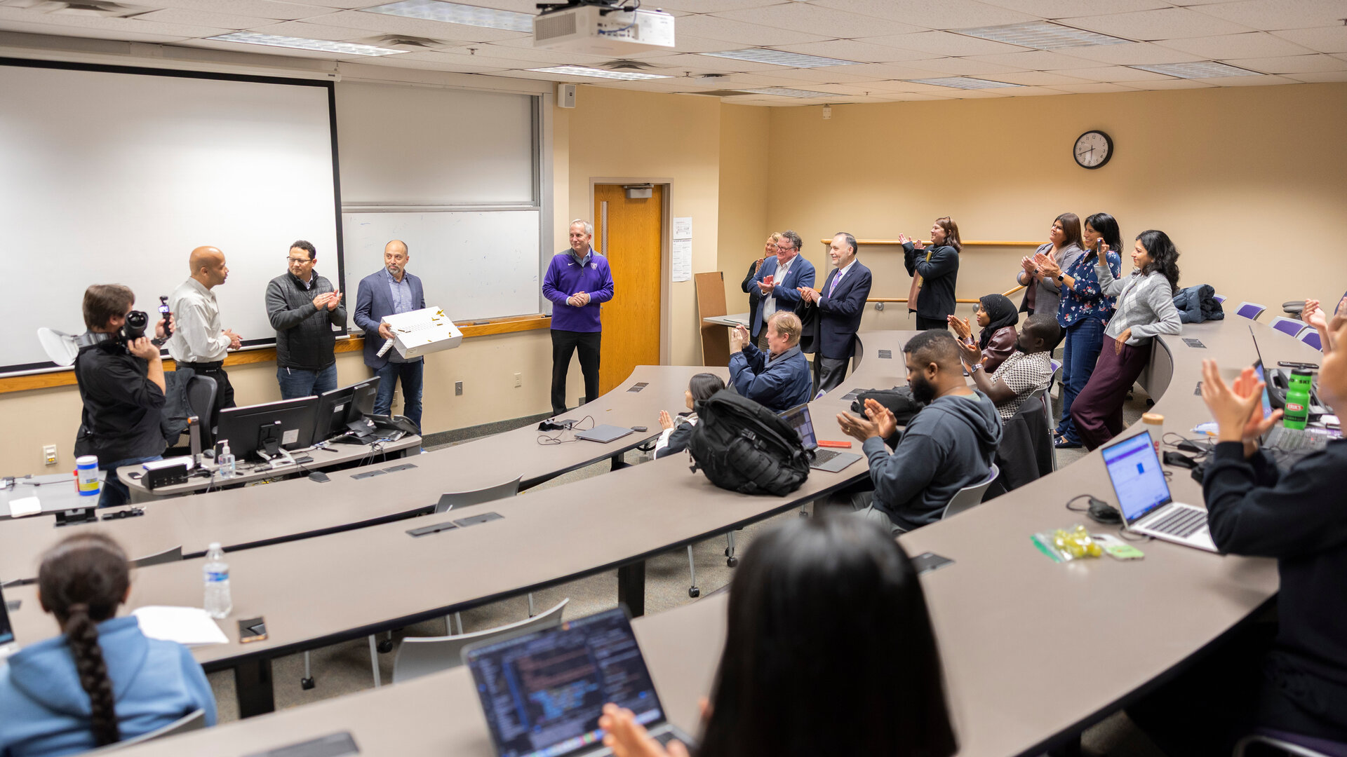 St. Thomas professor Dr. Manjeet Rege gets a surprise from his graduate students.