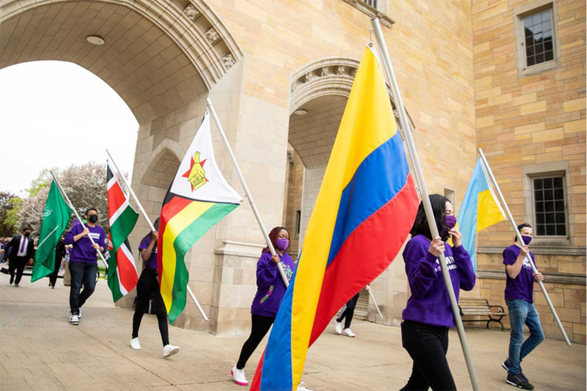 International Freshman students carry their country’s flags.